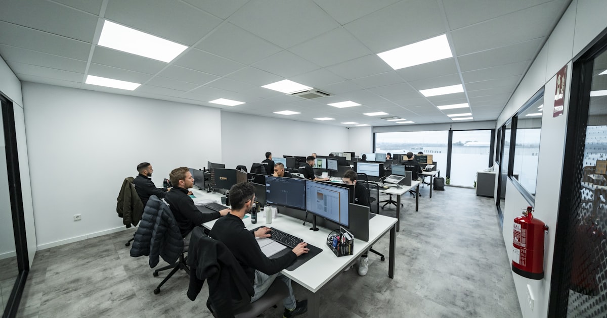 Office workers are busy working on computers.