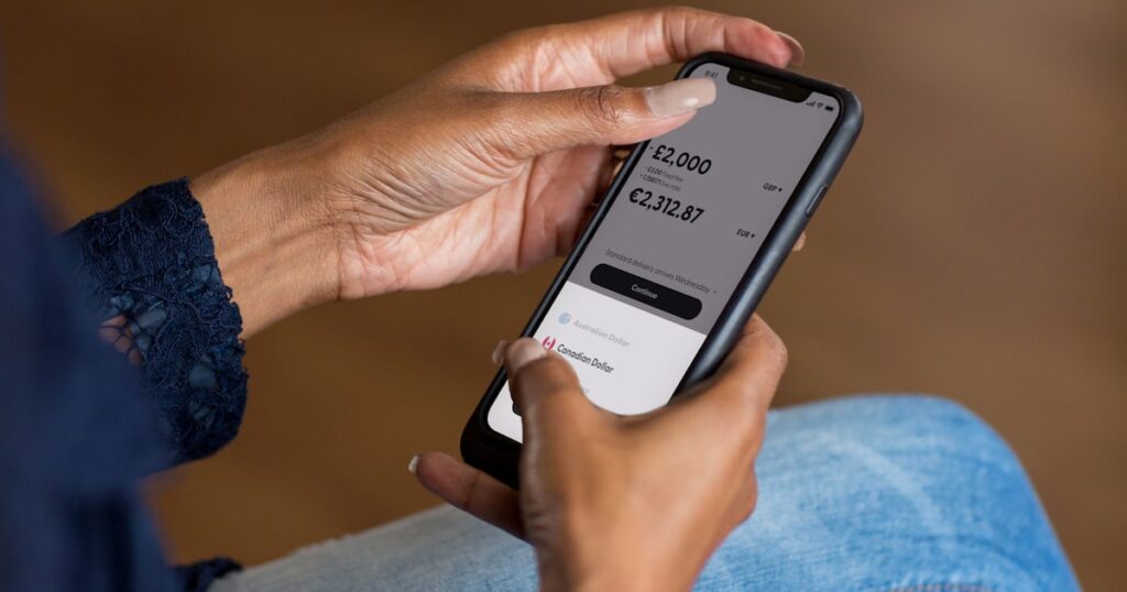 a woman holding a cell phone in her hand