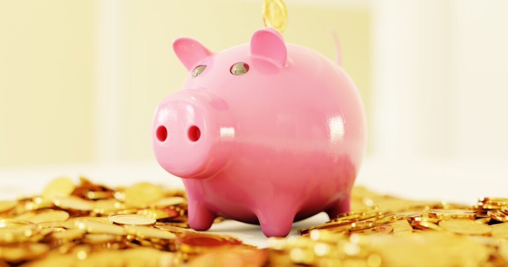 pink pig coin bank on brown wooden table