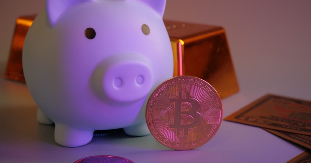 Piggy bank with bitcoin and gold bars