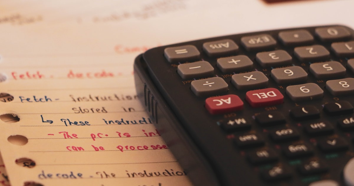 A scientific calculator with paper work