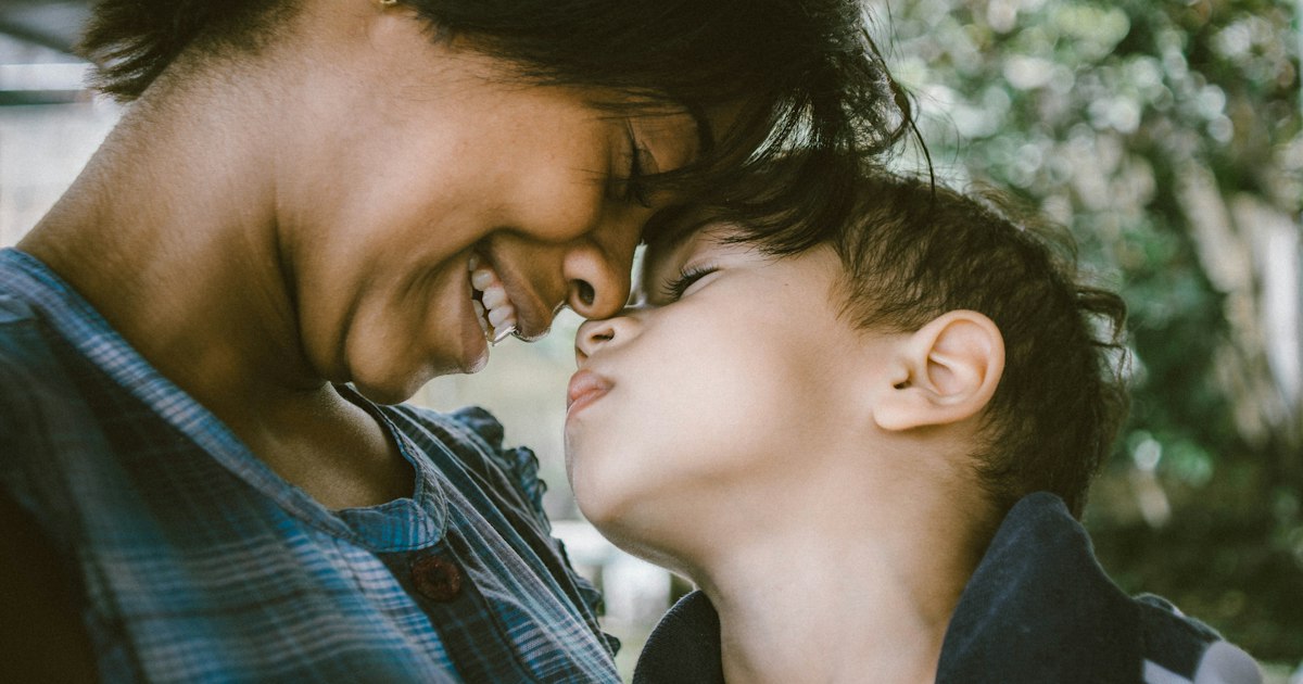 Woman and child touching faces