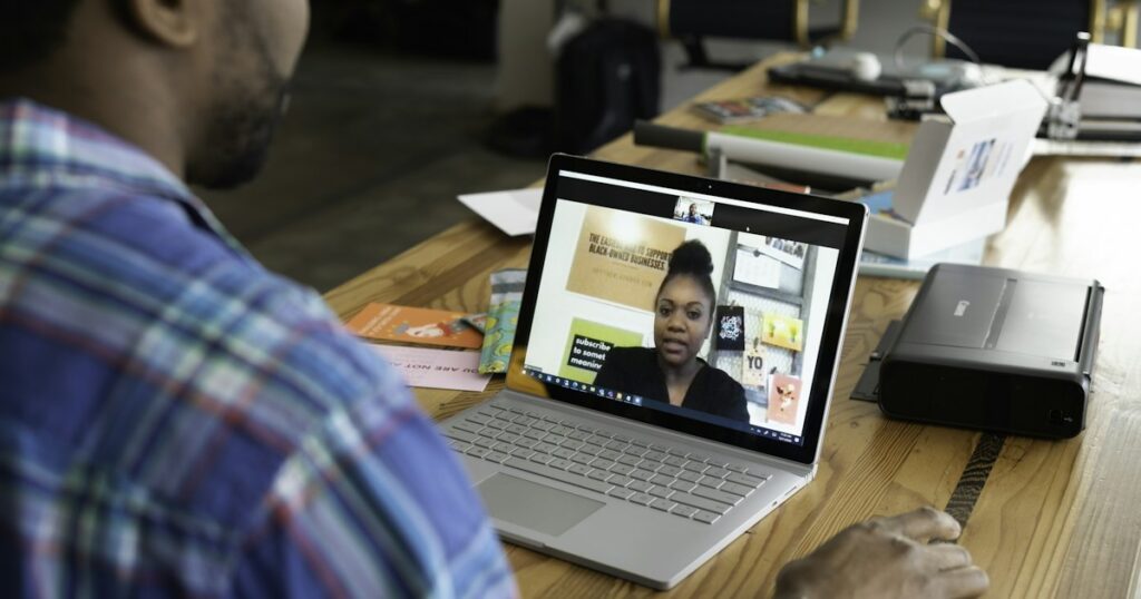 A salesperson working in an office on a virtual call